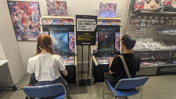 Two exA-Arcadia machines running Touhou Perfect Sakura, occupied by two players.