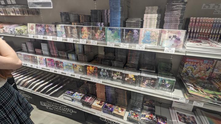 Store shelfs full of physical releases of Touhou video games and soundtracks in jewel case packagings.