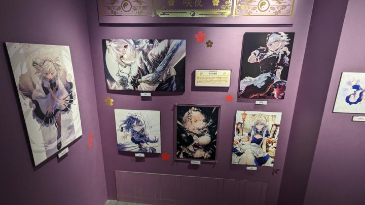 Works depicting Sakuya Izayoi drawn by different artists hanging on the wall