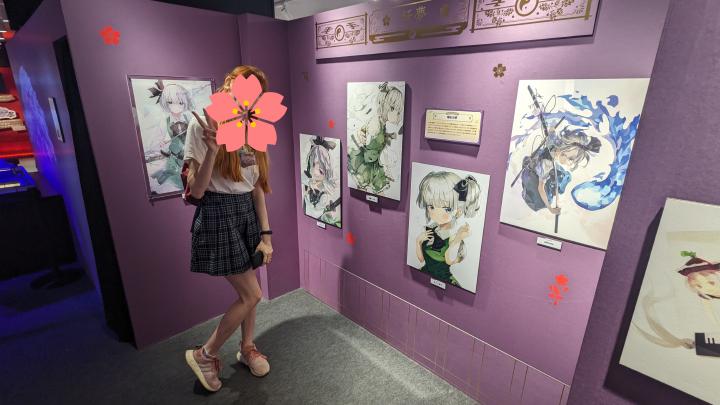 Works depicting Youmu Konpaku drawn by different artists hanging on the wall